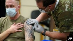Seorang anggota Tentara AS menerima dosis pertama vaksin COVID-19 Pfizer di markas tentara Lewis-McChord di negara bagian Washington, pada 16 Desember 2020. (Foto: AP/Ted S. Warren)