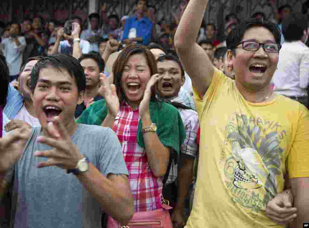 Supporters of Myanmar's National League for Democracy party cheer as they watch early voting results outside the NLD headquarters in Yangon, Myanmar, Nov. 8, 2015.