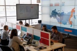 FILE - Activist supporters of Kremlin critic Alexei Navalny are seen monitoring elections at the office of Navalny's Anti-Corruption Foundation (FBK), in Moscow, Russia, March 18, 2018.