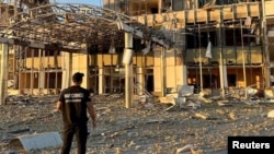 A member of Odesa Regional Prosecutor's Office personnel inspects damage following a Russian military attack in Odesa, Ukraine, in this image released Sept. 25, 2023.
