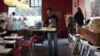 Waiter Terence Kamanda poses for a picture as he serves customers in The Corner Cafe restaurant in Durban, April 26, 2012. 