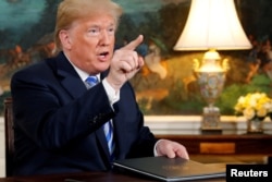 FILE - U.S. President Donald Trump speaks to reporters after signing a proclamation declaring his intention to withdraw from the Iran nuclear agreement in the Diplomatic Room at the White House in Washington, May 8, 2018.