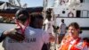 In this photo taken Aug. 9, 2018, migrants disembark from the Open Arms boat, in Algeciras, Spain, after being rescued off the coast of Libya in the early hours of Aug. 2, 2018. 
