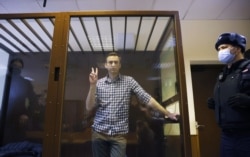 FILE - Russian opposition leader Alexey Navalny attends a hearing to consider an appeal against an earlier court decision to change his suspended sentence to a real prison term, in Moscow, Russia, Feb. 20, 2021.
