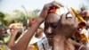 The mother of a missing Chibok girl reacts during a march with other women to the presidential villa in Abuja, Nigeria, calling for their daughters to be brought back home, Jan. 14, 2016.