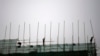 FILE - Laborers work at a construction site in Beijing, April 16, 2014.