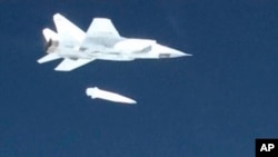 FILE - In this video grab provided by RU-RTR Russian television via AP television, March 1, 2018, a Russian MiG-31 fighter jet releases a Kinzhal hypersonic missile during a test at an undisclosed location in Russia.