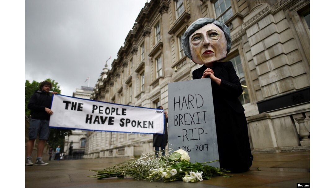 A protester wearing a Theresa May mask is seen the day after Britain's election in London, June 9, 2017.