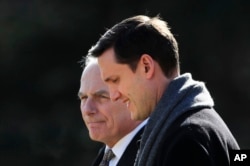 White House staff secretary Rob Porter, right, walks with White House Chief of Staff John Kelly to board Marine One on the South Lawn as they leave the White House in Washington, Feb. 2, 2018.