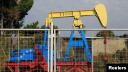 An oil pumpjack painted with the colors of the Venezuelan flag is seen in Lagunillas, Venezuela Jan. 29, 2019.