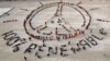 FILE - Environmental activists form human chains representing the peace sign and spelling out "100% renewable," on the sidelines of the 2015 Paris Climate Summit, near the Eiffel Tower in Paris, France, Dec. 6, 2015.