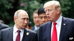 Arhiva - Predsednik SAD Donald Tramp sa predsednikom Rusije Vladimirom Putinom razgovara tokom foto sesije na samitu APEC-a, u Danangu, Vijetnam, 11. novembra 2017.
