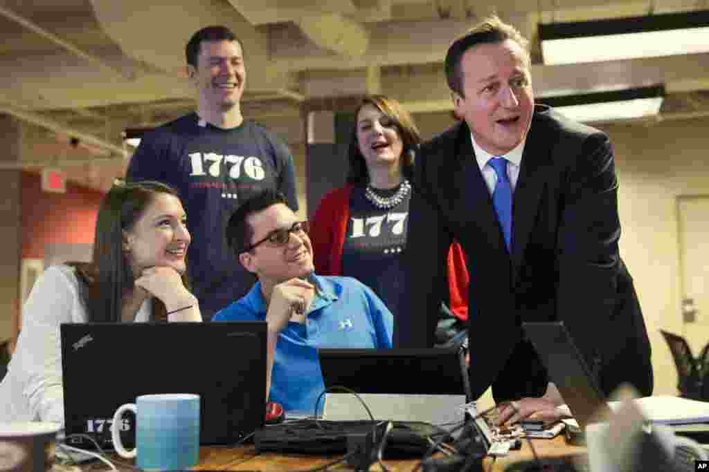 British Prime Minister David Cameron visits with people working at ‘1776’, a hub for tech startups before his meeting with President Barack Obama at the White House, in Washington, Jan. 16, 2015.