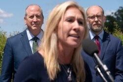 FILE - Rep. Marjorie Taylor Greene, R-Ga., center, speaks during a news conference, May 12, 2021.