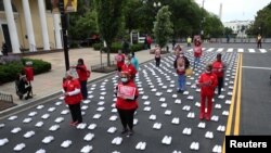 National Nurses United (NNU) holds a protest against working conditions and a gathering to honor the more than 400 registered nurses who have died from COVID-19, outside of the White House in Washington, May 12, 202…