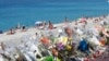 FILE - Flowers and messages are placed along the beach of the Promenade des Anglais in Nice, southern France, July 20, 2016.