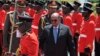 FILE - Sudan's then-President Omar al-Bashir inspects the guard of honor upon his arrival in Entebbe, Uganda, Nov. 13, 2017. Uganda says it will consider giving asylum to the deposed leader. 