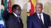 Zimbabwe's President Robert Mugabe (L) gestures as South Africa's President Jacob Zuma looks on at the end of a press briefing at the Union building in Pretoria, April 8, 2015.