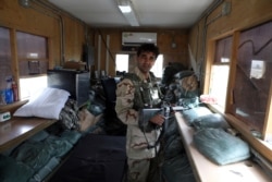 Afghan security forces stand guard after the American military left Bagram air base, in Parwan province north of Kabul, Afghanistan, July 5, 2021.