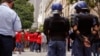 FILE - South African police provide security as Parliament workers, rear, protest against low wages in Cape Town, South Africa, Nov. 11, 2015. 