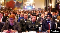 FILE - Australia's Defense Minister Marise Payne (L-R), China's PLA Lieutenant-General He Lei and Canada's Defense Minister Harjit Sajjan listens to U.S. Secretary of Defense Jim Mattis' address at the IISS Shangri-la Dialogue in Singapore, June 2, 2018.