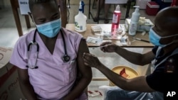 A doctor receives a Johnson & Johnson vaccine at the government hospital in Klerksdorp, South Africa, Feb. 18, 2021. 