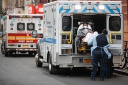 Patients are brought into Wyckoff Heights Medical Center by staff wearing personal protective gear due to COVID-19 concerns, in the Brooklyn borough of New York, April 7, 2020.