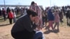 Dasia Pleitez prays as she waits for her daughter at a unification site following a shooting at the Antioch High School in Nashville, Tennessee, Jan. 22, 2025.