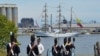 To kick off the 200th anniversary of the War of 1812, ships from around the world sailed past Fort McHenry and exchanged canon fire with re-enactors on land, but it was all for show. (S. Logue/VOA)