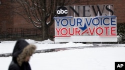 A person walks on the Saint Anselm College campus, ahead of a Democratic party debate in Manchester, N.H., Feb. 7, 2020.