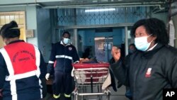 FILE - A COVID-19 patient is admitted to a hospital in Johannesburg, June 23, 2021. 