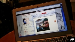 This screen shot shows Chinese Patriotic Blogger, Zhou Xiaoping's Sina Weibo account and his selfie near Chinese President Xi Jinping with officials at the Great Hall of the People, in his blog, in Beijing, China Thursday, Oct. 23, 2014. 