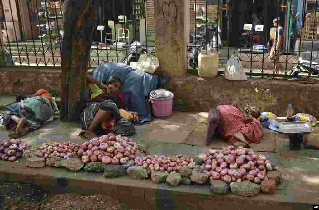 A severe heat wave sweeping much of India has left hundreds dead. In this photo, Indian vendors rest under the shade of a tree, in Hyderabad, May 25, 2015. 