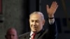 Israeli Prime Minister Benjamin Netanyahu waves during the opening ceremony for a bomb-proof emergency room in a hospital in Ashkelon, Feb. 20, 2018.
