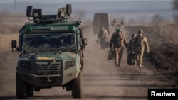 Ukrainian servicemen are seen near the frontline near Soledar in Donetsk region, Jan. 23, 2023. 