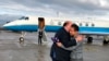 This photo provided by U.S. Embassy Switzerland, Edward McMullen greets Xiyue Wang in Zurich, Switzerland on Saturday, Dec. 7, 2019. 