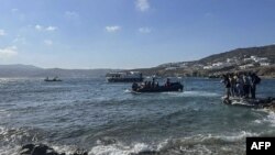 FILE - This handout picture released by the Hellenic Coast Guard on June 19, 2022 shows rescued migrants during their transfer to Mykonos island. (AFP photo / Hellenic Coast Guard) 