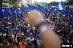 Supporters of President and National Party presidential candidate Juan Orlando Hernandez celebrate as they wait for official presidential election results in Tegucigalpa, Honduras, Nov. 28, 2017.