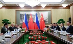 FILE - Philippine President Rodrigo Duterte, left, and Chinese President Xi Jinping, right, meet at the Diaoyutai State Guesthouse in Beijing, China, Aug. 29, 2019.