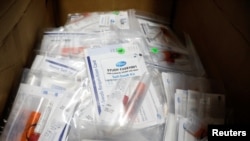 FILE - Trial kits for Pfizer's COVID-19 vaccination study are seen at the Research Centers of America, in Hollywood, Florida, Sept. 24, 2020.
