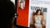 FILE - A journalist looks at Vanity Fair's Twitter site with the tweet about Caitlyn Jenner, the transgender Olympic champion formerly known as Bruce, June 1, 2015. 