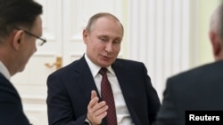 FILE - Russian President Vladimir Putin at the Kremlin in Moscow, March 19, 2018.