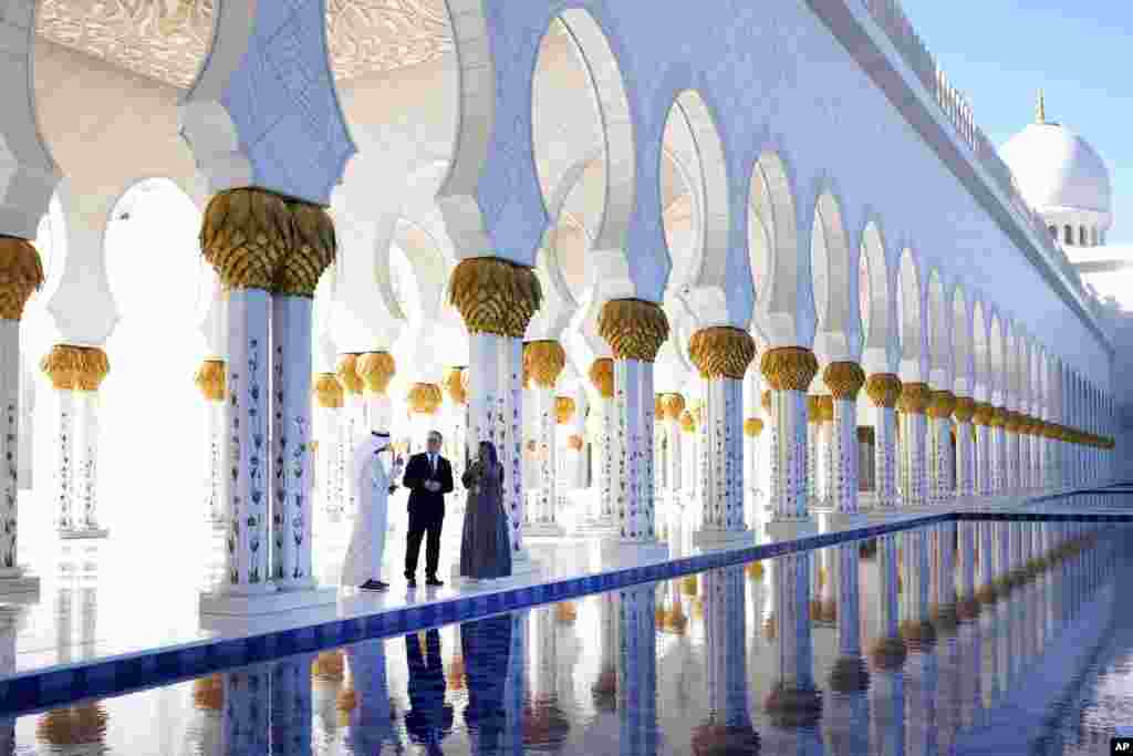 Britain's Prime Minister Keir Starmer is lead by Director General Yousif Alobaidli and tour guide Mahra, right, as he visits the Sheikh Zayed Grand Mosque in Abu Dhabi, United Arab Emirates.
