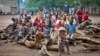 A group of Burundian refugee children sit on a pile of wood, at the Gashora refugee camp in the Bugesera district of Rwanda, April 21, 2015. Officials in Burundi say refugees in neighboring Rwanda are being recruited to fight against the Burundian government.