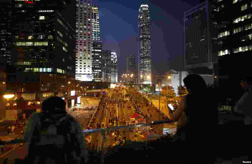 Pro-democracy demonstrators block a main street to the financial district outside the government headquarters office, in Hong Kong, Oct. 10, 2014.