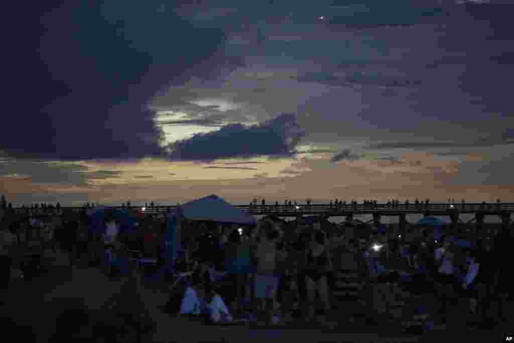 The Isle of Palms beach in South Carolina, turns dark during the solar eclipse, Aug. 21, 2017.