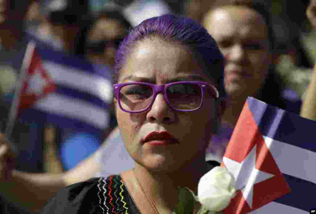 Jovem mulher presta homenagem pública o antigo presidente cubano Fidel Castro, em frente à embaixada de Cuba no México, 27 Nov 2016 
