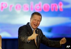 Republican presidential candidate Ohio Gov. John Kasich pumps his fist and celebrates before speaking at his presidential primary election rally in Berea, Ohio, March 15, 2016.