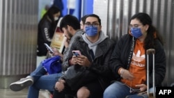 Passengers wearing protective masks are seen at the International Airport in Mexico City, Mexico, Feb. 28, 2020.