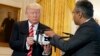George Mathew, CEO of Kespry, shows a drone to President Donald Trump during the "American Leadership in Emerging Technology" event in the East Room of the White House, June 22, 2017, in Washington.